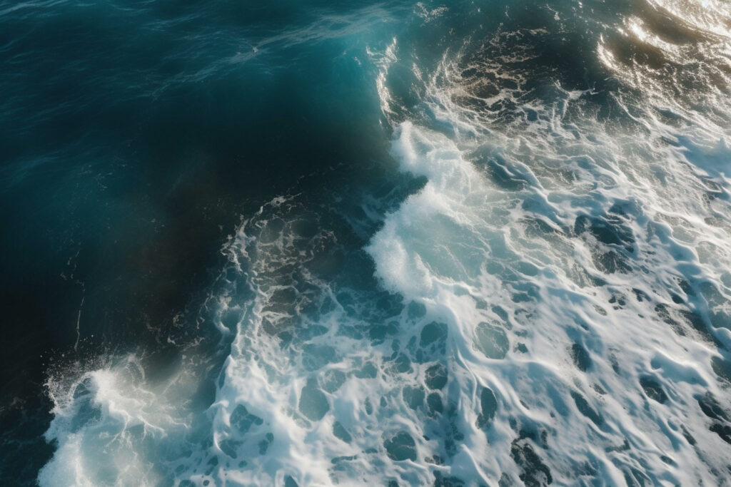 Overhead shot of crashing waves in clear blue Bali sea. Protect the environment through climate disclosure and sustainability reporting with NZCS1, TCFD, IFRS S2, and climate related financial disclosures.